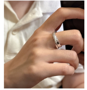 Close-up of S925 sterling silver ring with a textured lava design on a model finger