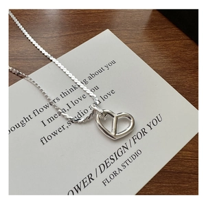 Close-up of S925 sterling silver hallmark on minimalist hollow heart pendant necklace