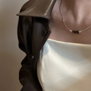 S925 sterling silver minimalist necklace with natural brown stones on a model's neck