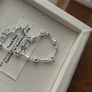 Minimalist S925 sterling silver knuckle bone bracelet with adjustable clasp on tray