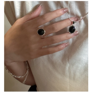 Close-up of S925 sterling silver jewelry set featuring black agate and wrinkled texture