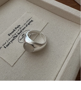 Close-up of matte S925 silver ring with oval translucent gray agate in minimalist style