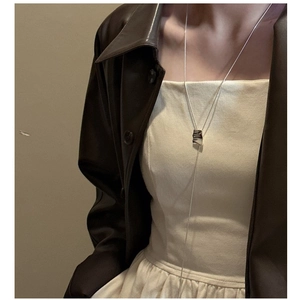 Close-up of a long S925 silver Y-shaped necklace with irregular square pendant on model