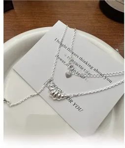 Vue détaillée du pendentif croissant en argent S925 sur un support en porcelaine blanche