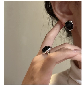 Detail of S925 sterling silver ring and earring set with black onyx texture design