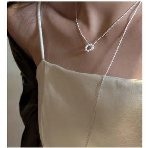 Detail of S925 silver long necklace with circular baroque pearl pendant on model