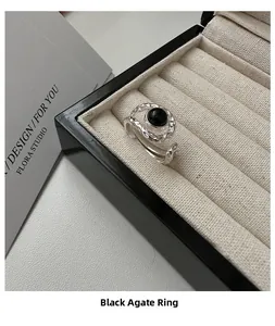 Detail of vintage S925 silver ring with hammered texture and black agate stone