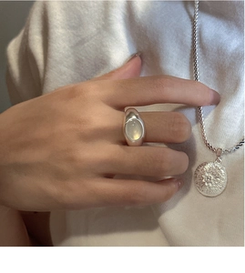 Detail of S925 sterling silver ring with oval stone and beaded sun pendant necklace