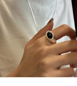 Detail of S925 sterling silver ring featuring a matte finish and oval black agate stone