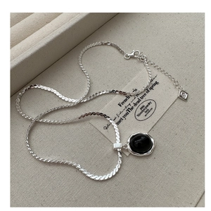 Détail de la chaîne serpent en argent S925 et du pendentif agate noire à bords ondulés