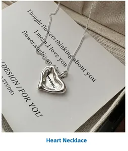 Detail of S925 sterling silver heart necklace with boram engraving on linen fabric