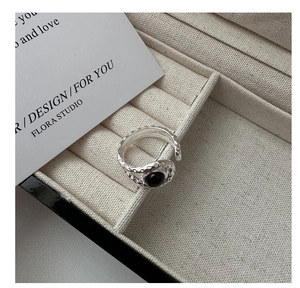 Detail of hammered S925 silver ring with round black agate stone on velvet box