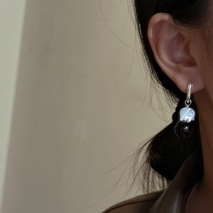 Minimalist S925 sterling silver elephant earrings with black agate beads on female ear