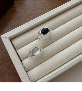 Detailed macro view of matte S925 silver rings with black onyx and opal-like oval stones