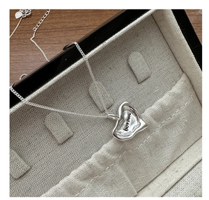Detail of S925 sterling silver heart pendant with boram engraving and cross chain link