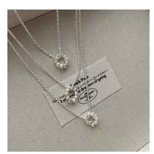 Close-up of S925 silver necklace set featuring elegant baroque pearl circle pendants