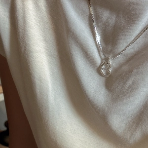 Minimalist S925 sterling silver hollow heart pendant necklace worn on a casual outfit