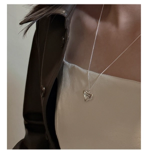 Close-up of S925 sterling silver asymmetric heart pendant with Love You engraving
