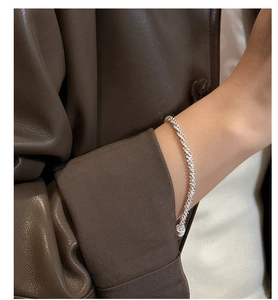 Detail of silver S925 tennis bracelet with shimmering micro-pave zircons on wrist