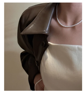 Close-up of sparkling S925 silver tennis necklace worn by a model in elegant style