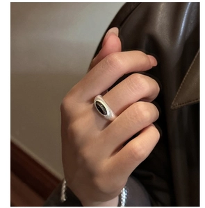Detailed close-up of S925 sterling silver ring with matte finish and black onyx gemstone