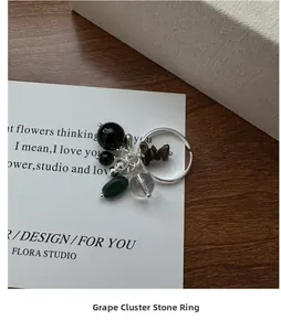 Detail of S925 silver open ring with grape cluster style gemstones and black beads