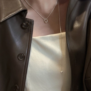 S925 sterling silver baroque pearl Y-necklace with heart pendant on model wearing leather