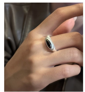 Macro detail of a silver S925 ring with matte finish and oval black onyx stone