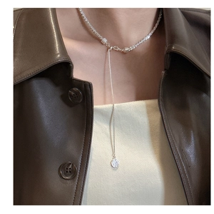 Close-up of S925 sterling silver tassel necklace with shimmering crushed silver texture