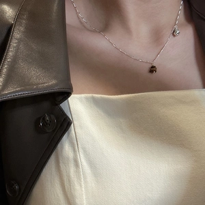 S925 sterling silver Saturn necklace with tiger eye stone pendant on a fashion model