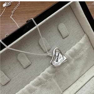 Macro shot of S925 silver irregular lava heart pendant with boram engraving on O-chain