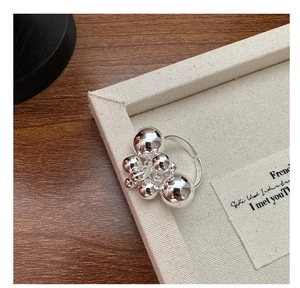 Detailed shot of S925 sterling silver multi-bead cluster ring on a cream canvas tray