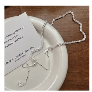 Detailed macro view of S925 sterling silver chain with wavy texture and lobster clasp