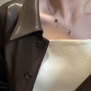 Minimalist S925 sterling silver Saturn pendant necklace on model with retro leather jacket