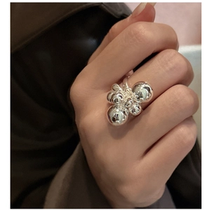 Macro detail of S925 sterling silver ring with cluster beads and polished mirror finish