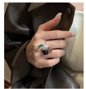Detail of beaded ring with turquoise and quartz stones on silver band worn by model