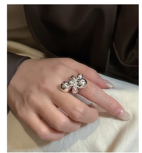 Close-up of a polished S925 sterling silver ring with unique beaded water droplet design
