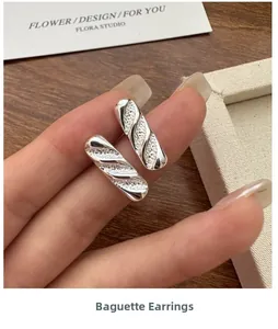 Detailed view of S925 sterling silver baguette stud earring with textured stripes