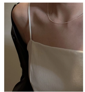 Detail of minimalist S925 sterling silver square snake chain necklace on neck