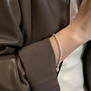 S925 sterling silver bracelet with wavy texture worn by a model on leather background
