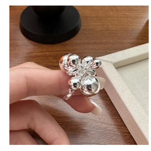 Macro detail of the polished silver ball cluster ring showing the unique 3D texture