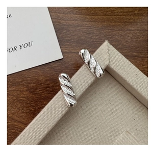 Close-up of S925 silver studs with baguette shape and textured hammered finish