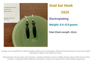 Detail of S925 sterling silver drop earrings with black elongated and green round beads