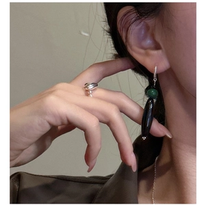 Close-up of S925 silver heart pearl ring and retro green beaded earrings on a model