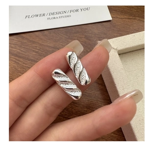 Close-up of S925 silver baguette-shaped stud earrings with textured diagonal stripes