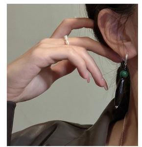 Detailed view of S925 silver teardrop agate earrings and pearl ring set on model