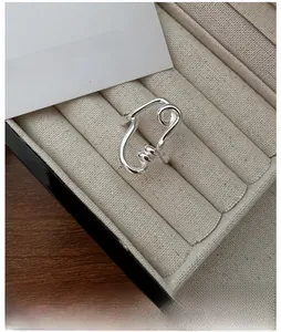 Macro shot of S925 sterling silver twisted ring with liquid metal texture in a box