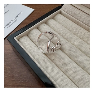 Detail view of S925 sterling silver twisted knot open ring on a jewelry display box