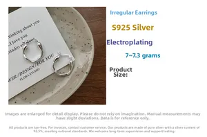 Detailed view of S925 sterling silver liquid streamline hoop earrings on display