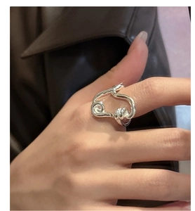 Close-up of polished S925 sterling silver ring with abstract twisted rope design on finger
